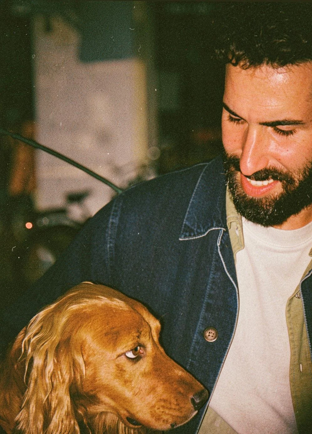 Shachar Bechor smiling with a brown dog
